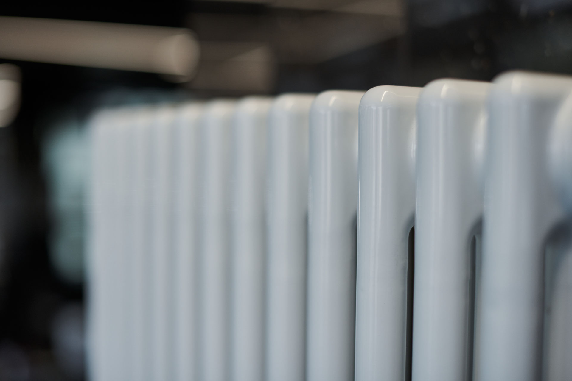 Heating radiator in office, close up. White heat exchangers. Iro